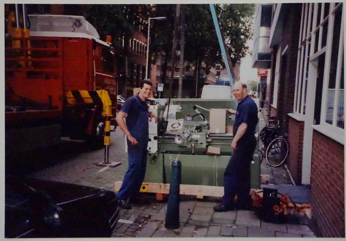 A high precision lathe is being hoisted into the factory.
